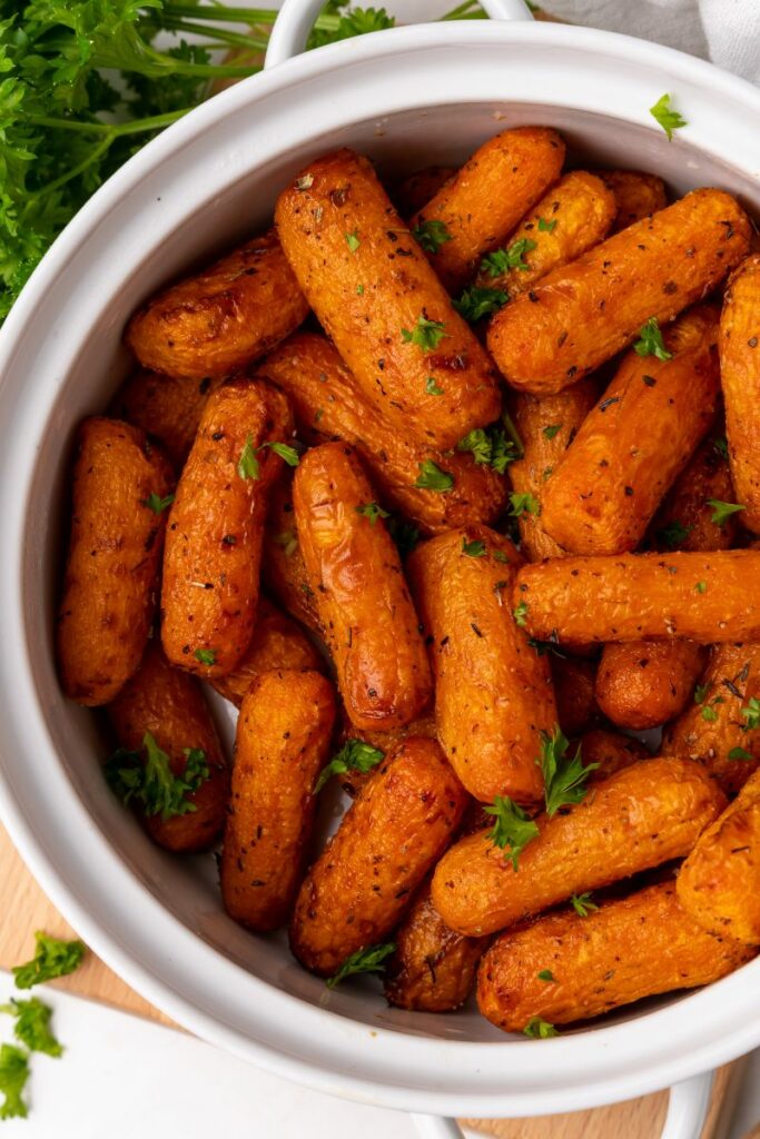 Air Fryer baby carrots with italian seasoning on top in a pot