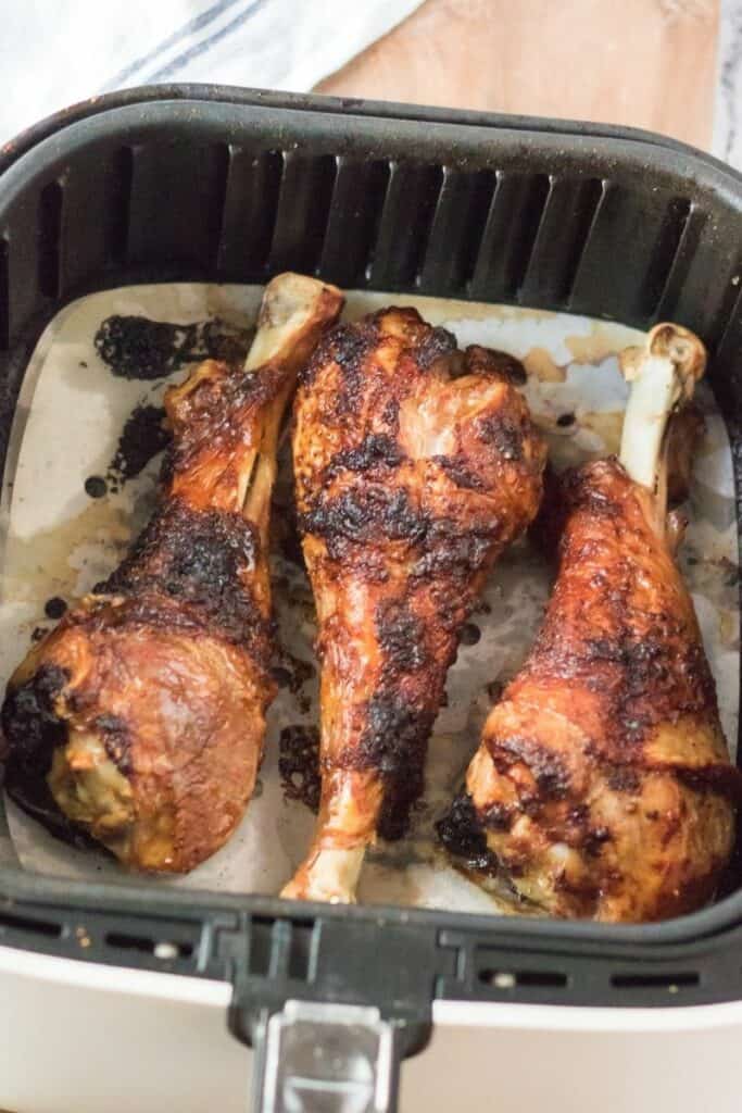 Turkey legs in air fryer with parchment paper liner