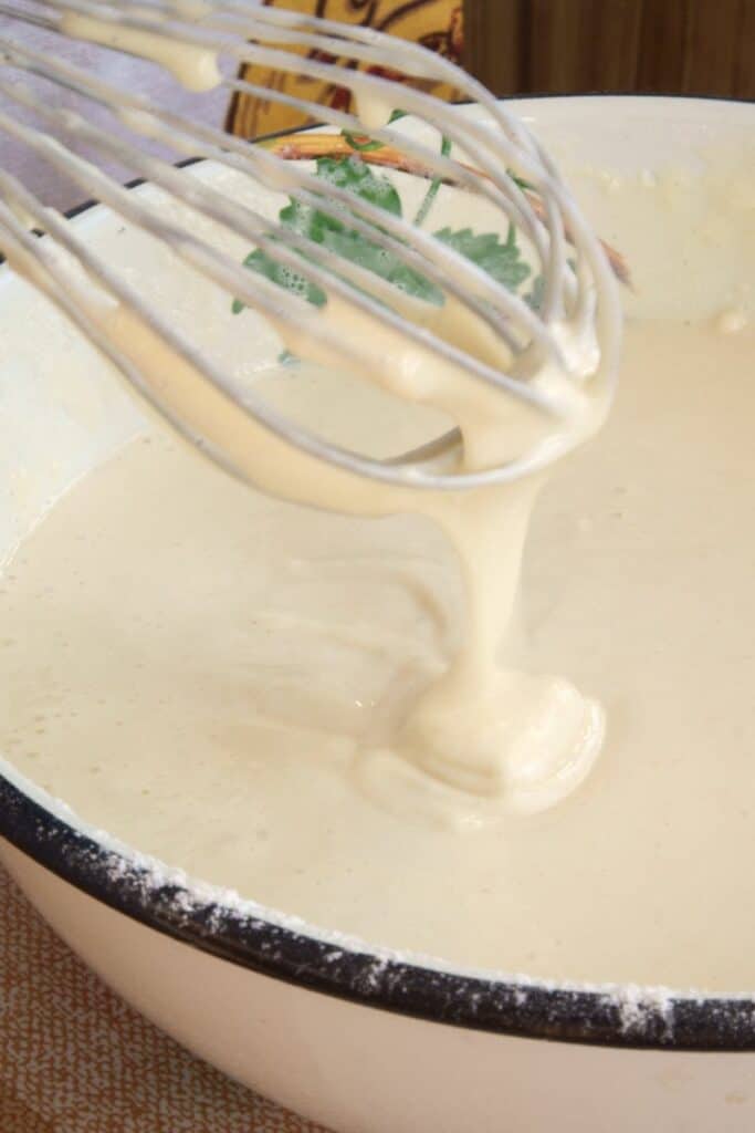 pancake batter in a bowl with a whisk